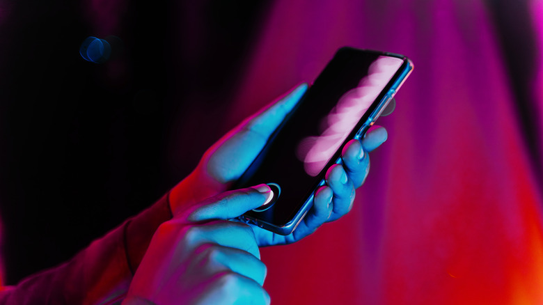 Person unlocking their smartphone using the fingerprint scanner