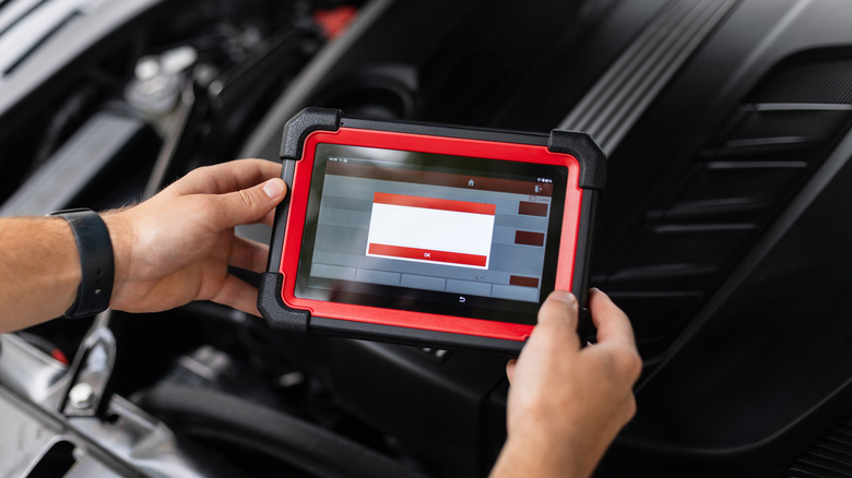 A technician using a higher end tablet-style OBD-II scanner