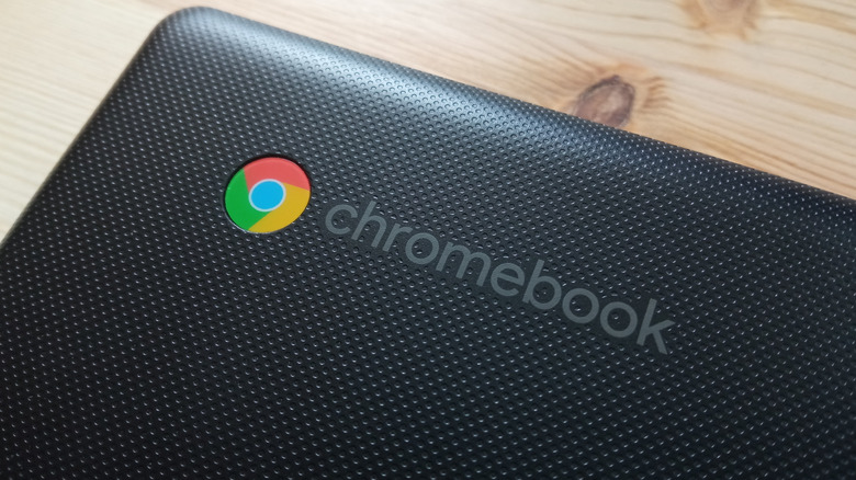 Close-up on a Chromebook laptop logo on a wooden desk