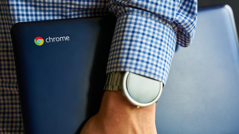Person holding Chromebook