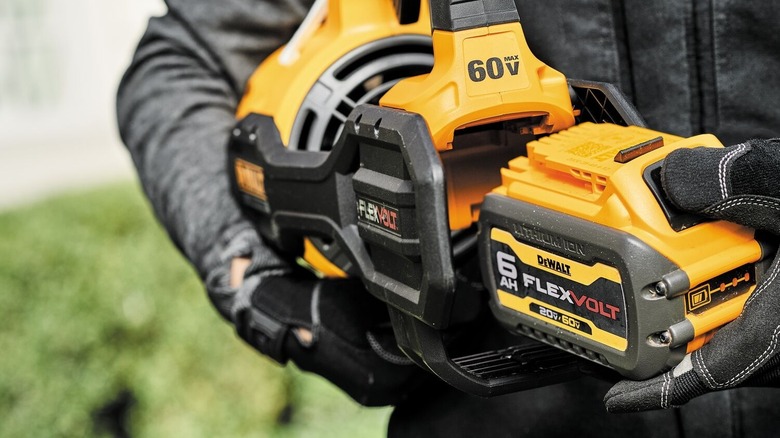Worker inserting DeWalt Flexvolt into tool