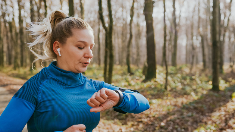 Person running with AirPods and Apple Watch
