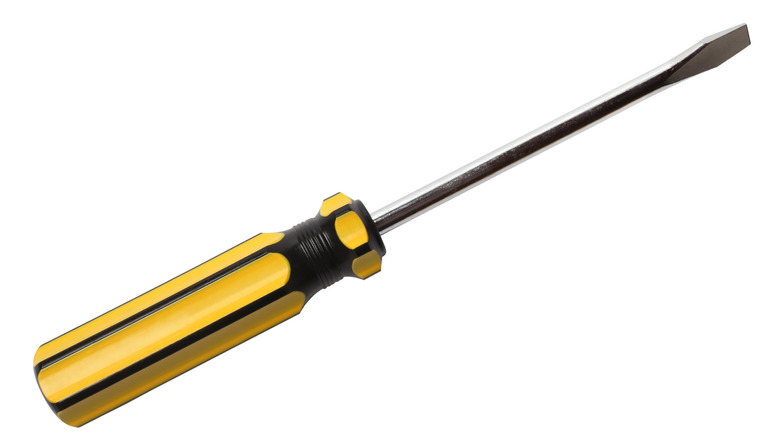 A screwdriver with a black and yellow handle isolated on white background.
