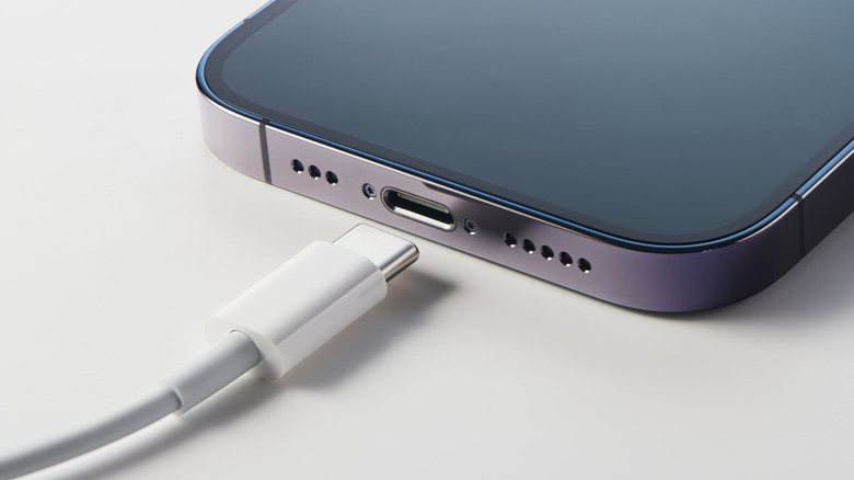 Close-up of iPhone USB-C port with a USB-C cable nearby