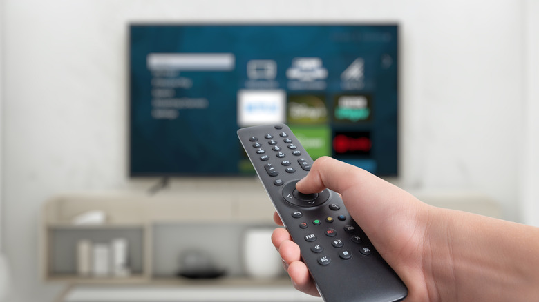 A person using a smart TV remote.