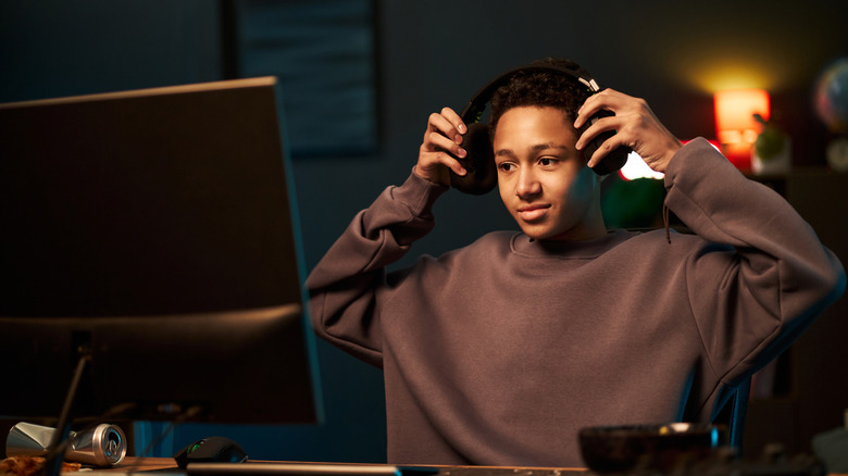Person wearing headphones using a monitor