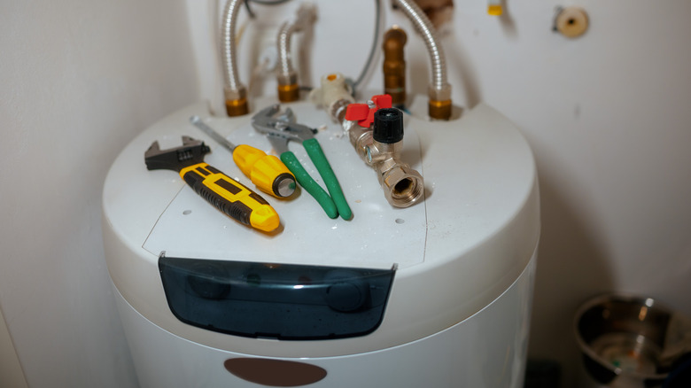 a set of tools resting on a clean water heater