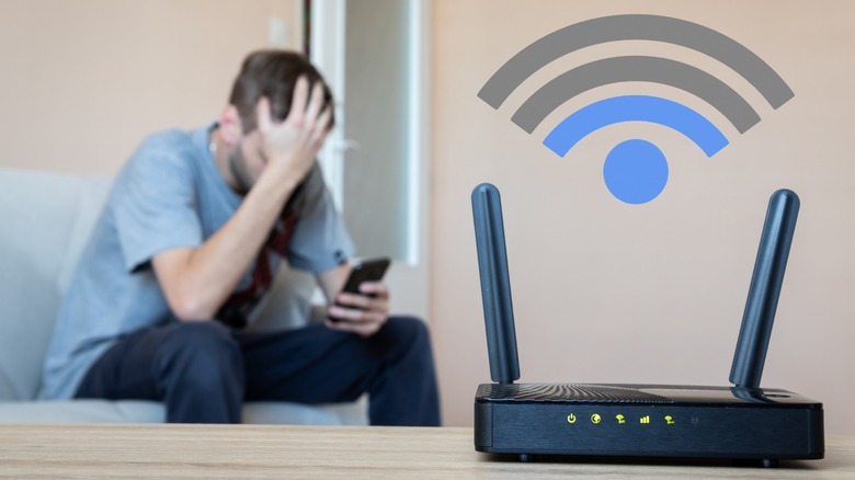 man with hand on forehead with router and signal icon