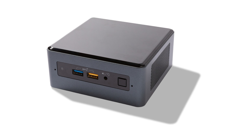 A black mini PC against a white background, showing the rear I/O