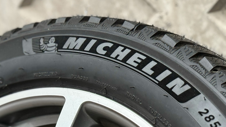 Michelin tire mounted on wheel with concrete in background