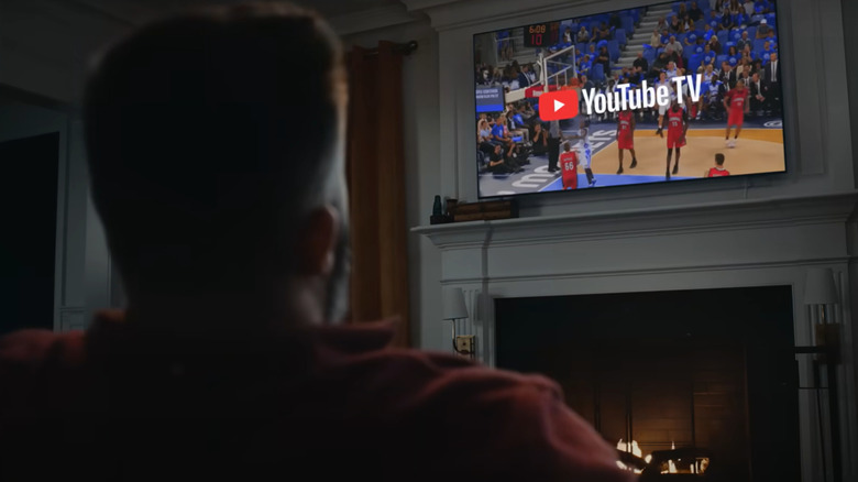 Jason Kelce watches a basketball game on YouTube TV during a commercial.