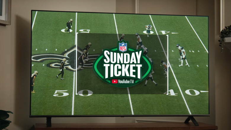 YouTube's Sunday Ticket logo is projected over a game between the Philadelphia Eagles and New Orleans Saints.