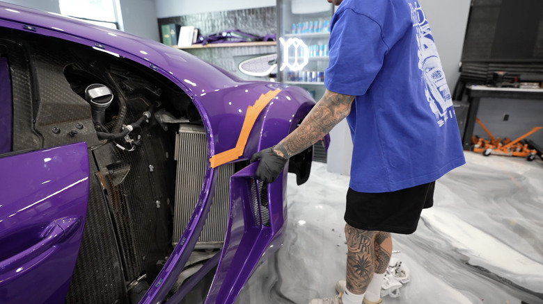 A Bugatti Chiron Pur Sports undergoes repairs in a workshop