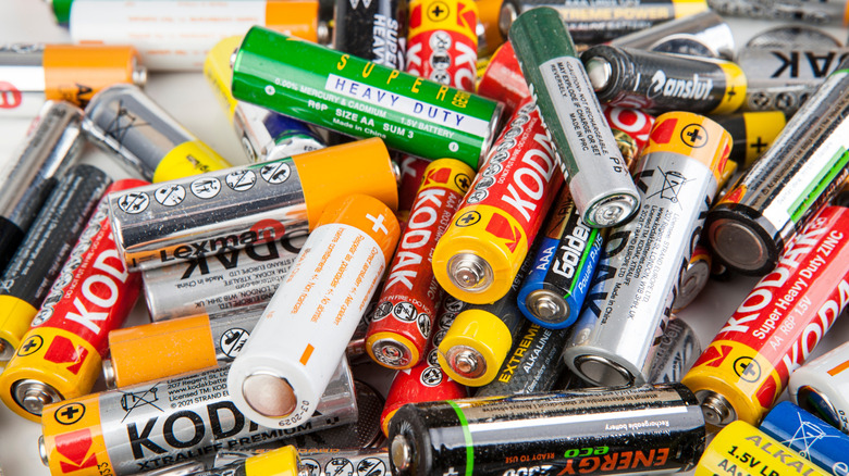 A pile of AA batteries from various brands