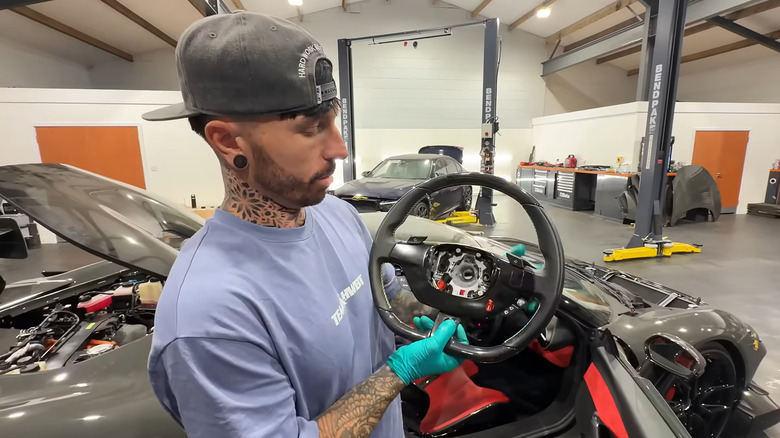 Mat Armstrong shows the replacement steering wheel that he bought
