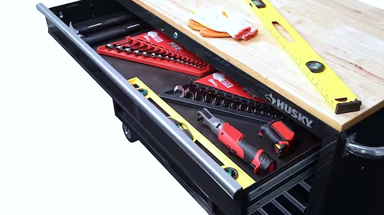 Tools inside an open Husky storage cabinet