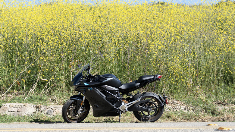 Zero SR/S parked in front of brilliant yellow mustard wildflowers