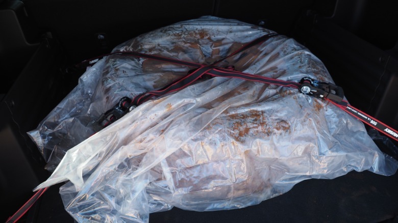 Flat tire of 2027 Honda Passport TrailSport wrapped in plastic and tied down in the rear cargo area