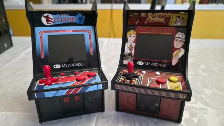 Two MyArcade mini game machines on a white tablecloth