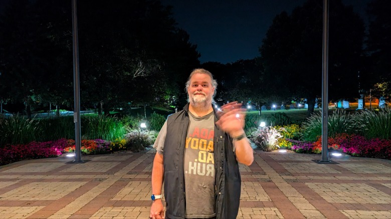 Man waving his hand in the dark