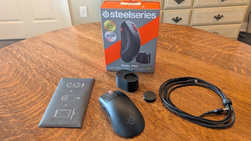 SteelSeries Rival Pro mouse next to all of its accessories