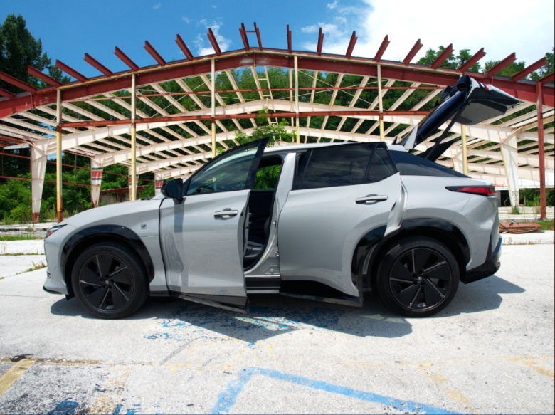 2026 Lexus RZ driver's side profile with driver's side doors and liftgate open