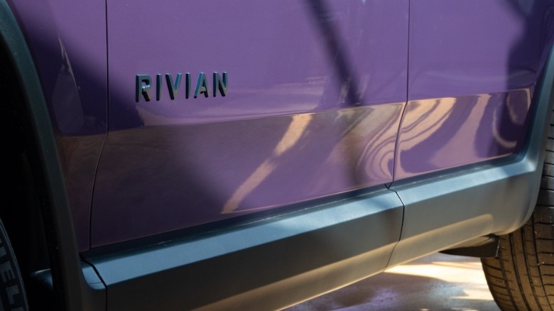 Side of Rivian vehicle with logo and Aurora Borealis paint