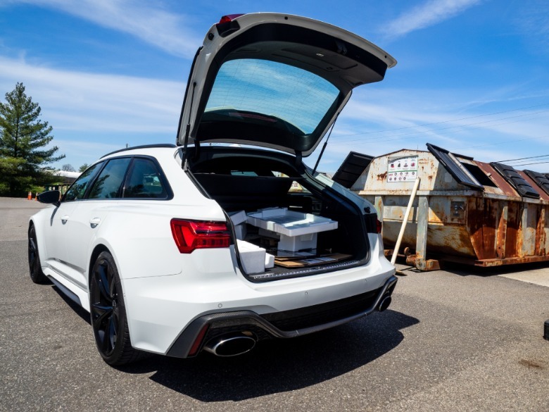 2026 Audi RS 6 Avant left rear three-quarter view with rear hatch open featuring a full cargo area
