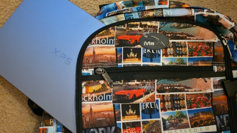 A Dell XPS 13 peeking out of a backpack