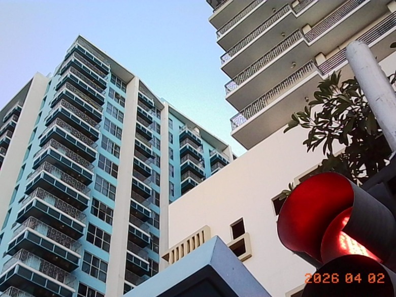 a photo of a tower with traffic lights in the foreground