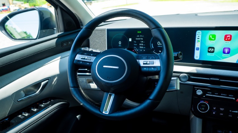 2026 Hyundai Tucson Hybrid steering wheel and dashboard with Apple CarPlay active
