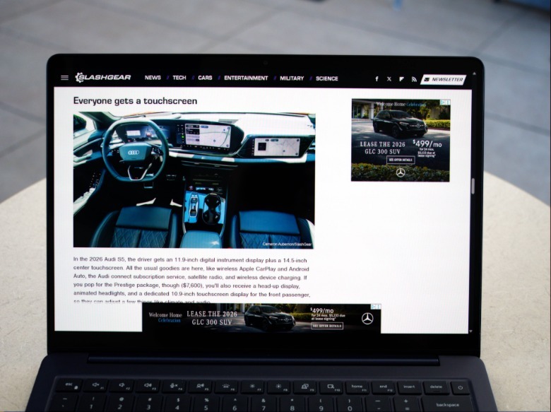 Dell 14S open on table with SlashGear automotive review on the screen