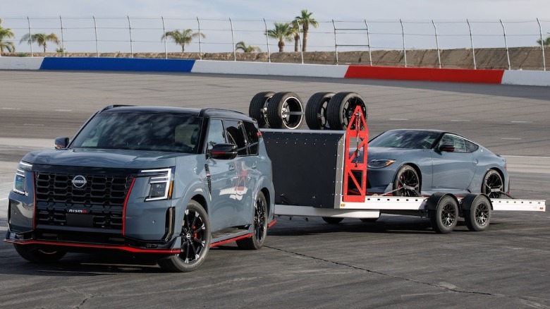 Nissan Armada Nismo towing a trailer carrying a Z Nismo