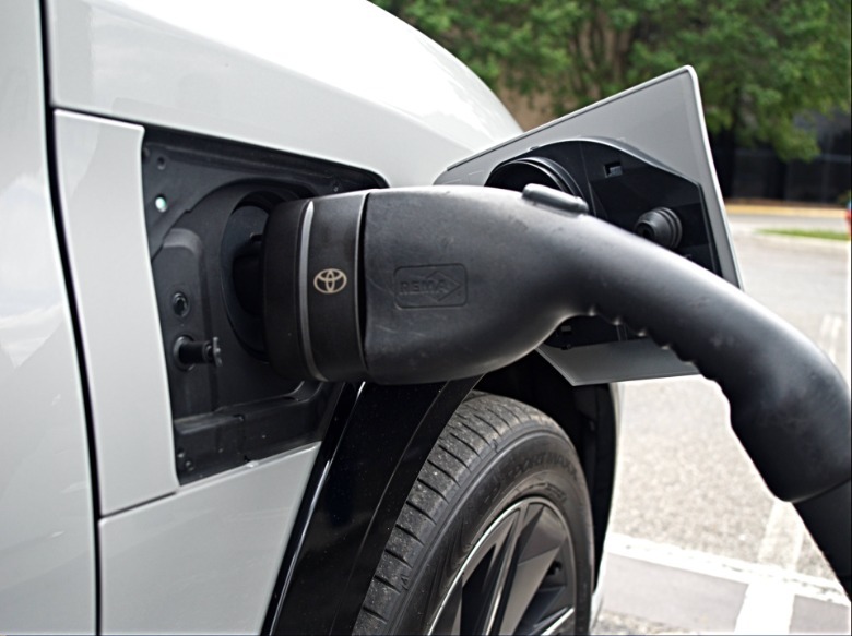 2026 Lexus RZ NACS charging port in use with CCS adapter at a charging station