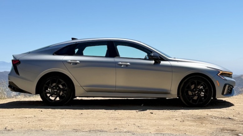 2026 Kia K5 GT-Line side profile parked on a mountainside