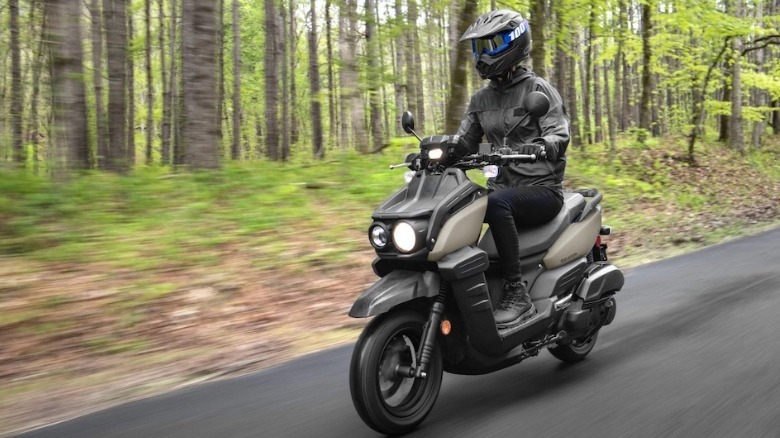 Yamaha Zuma 125 being ridden in a forest