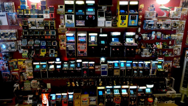 Miniature arcade machines in a big collection.