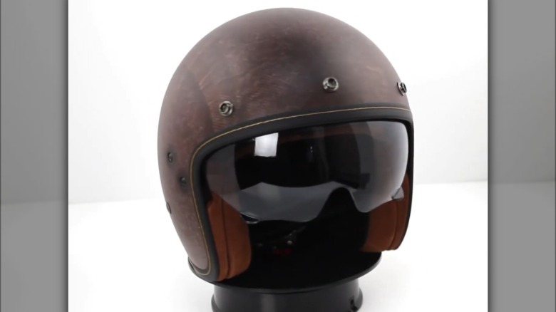 A '70s brown motorcycle helmet on display.