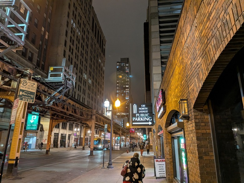 Exterior shot at night on street near brick building.