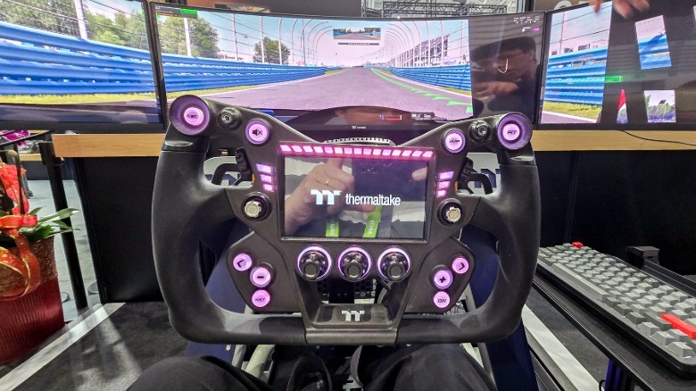 the author seated on the Thermaltake GR900 sim racing rig and about to take it for a spin