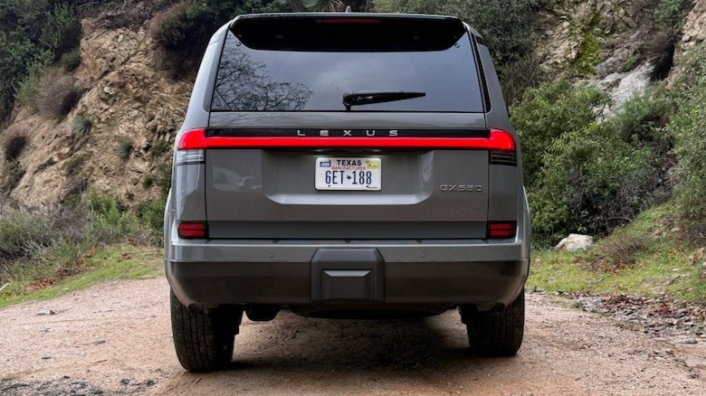 Rear view of a gray Lexus GX parked on a dirt road