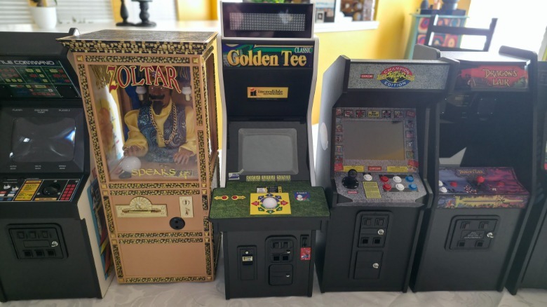 Several mini arcade machines from New Wave Toys arranged in a row