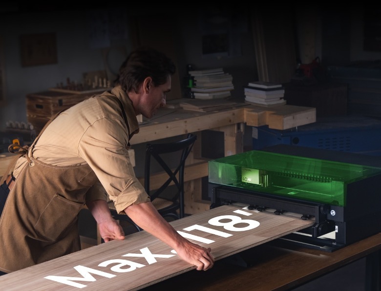 Person loading xTool S1 laser cutter