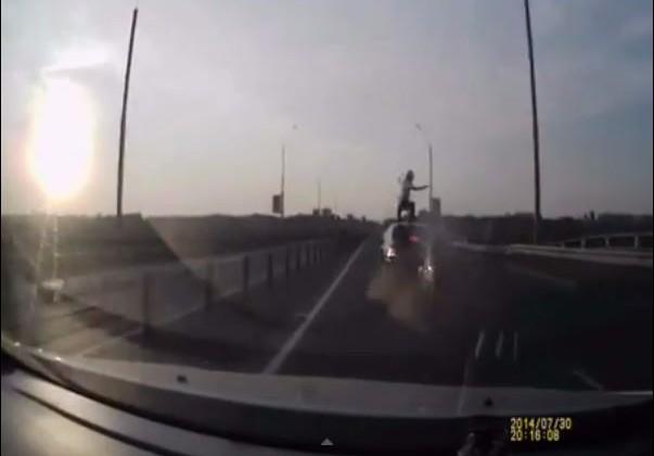 Motorcyclist pulls off superhero landing during crash