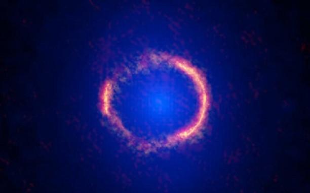 Einstein ring holds gargantuan galaxy at the edge of the Universe