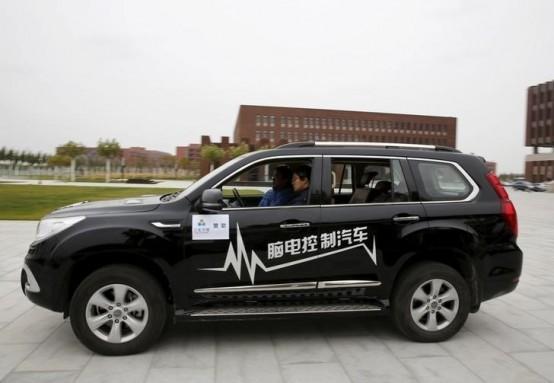 Researcher Zhang Zhao wearing a brain signal-reading equipment moves a car forward with his brain wave during a demonstration at Nankai University in Tianjin, China, November 17, 2015. REUTERS/Kim Kyung-Hoon