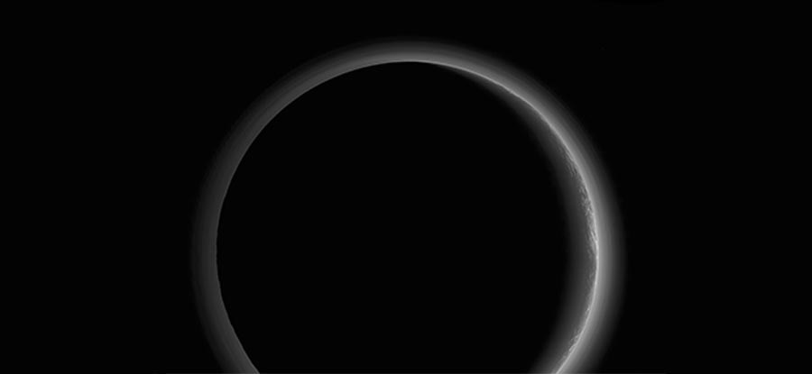NASA Pluto photo shows wispy clouds in a stunning glow