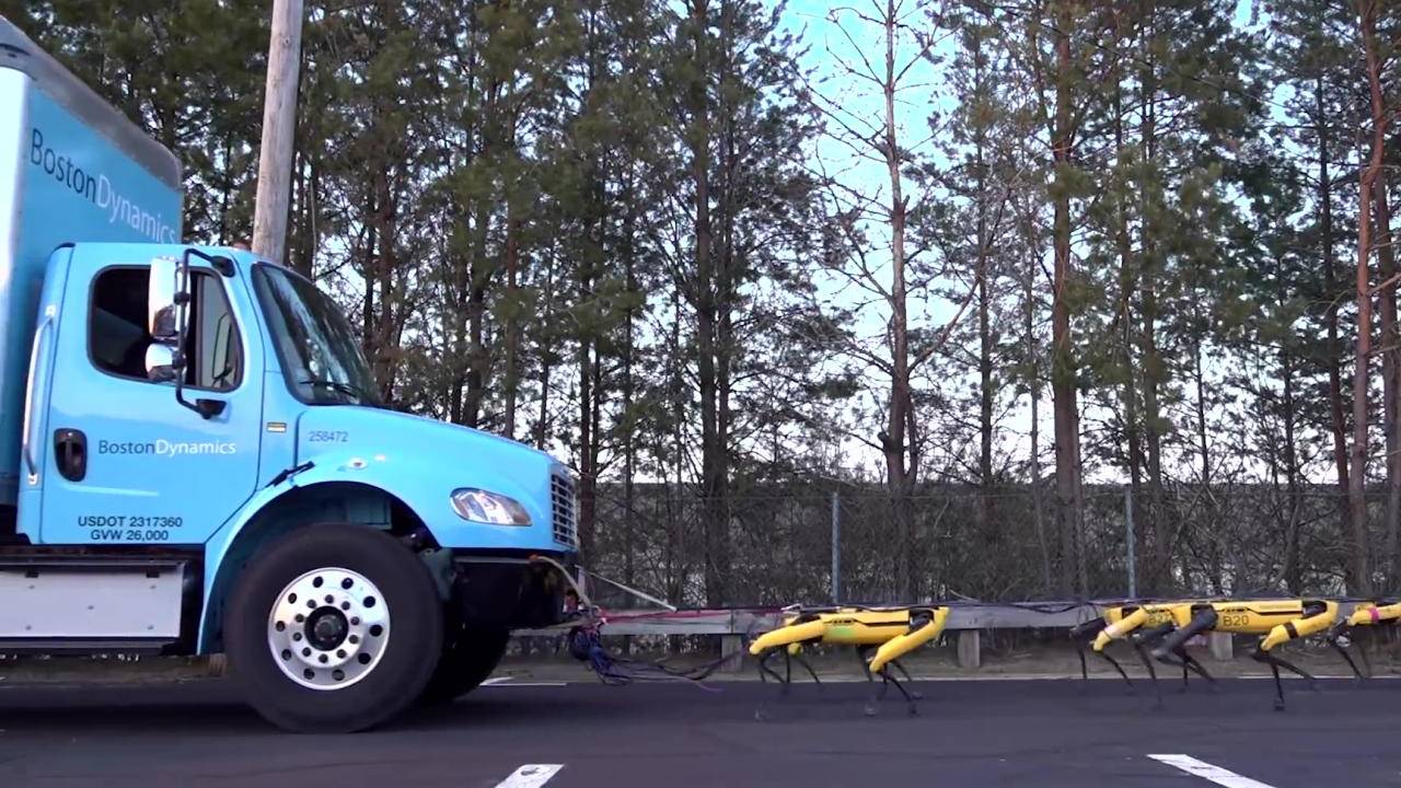Boston Dynamics’ SpotMini robots work together to pull a truck