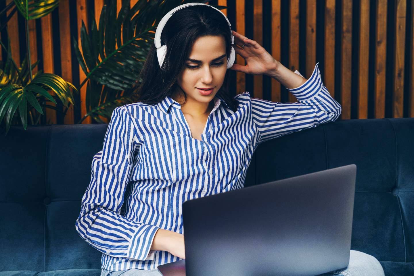 Woman listening to content on a laptop