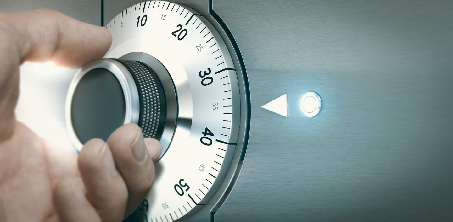 Hand opening a locked safe